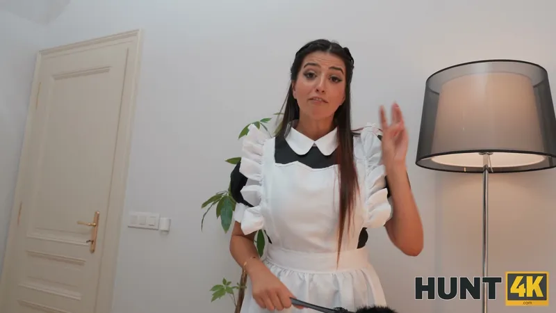In her maid's uniform she holds up three fingers