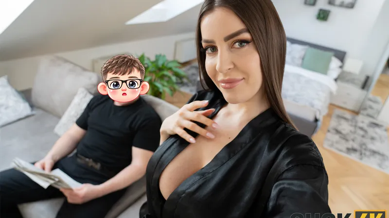 In a black satin robe she smiles at the camera while her husband holds the newspaper on the sofa behind her