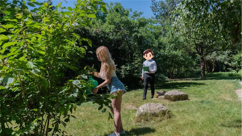 Billy walks across a sunny back garden toward Millie, who is watering the plants